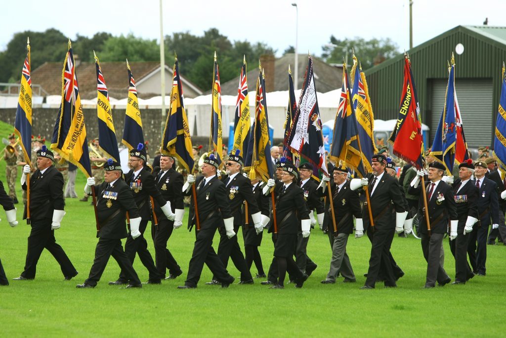 The British Legion standard bearers march into Market Park.