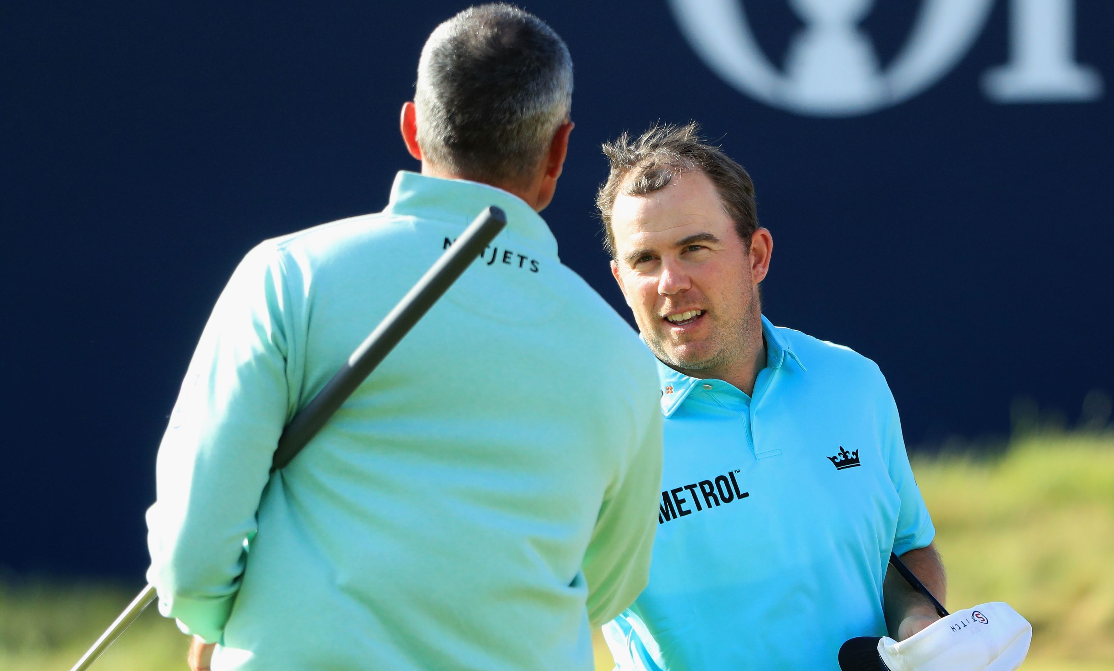 Richie Ramsay shakes hands with Matt Kuchar after their opening round.