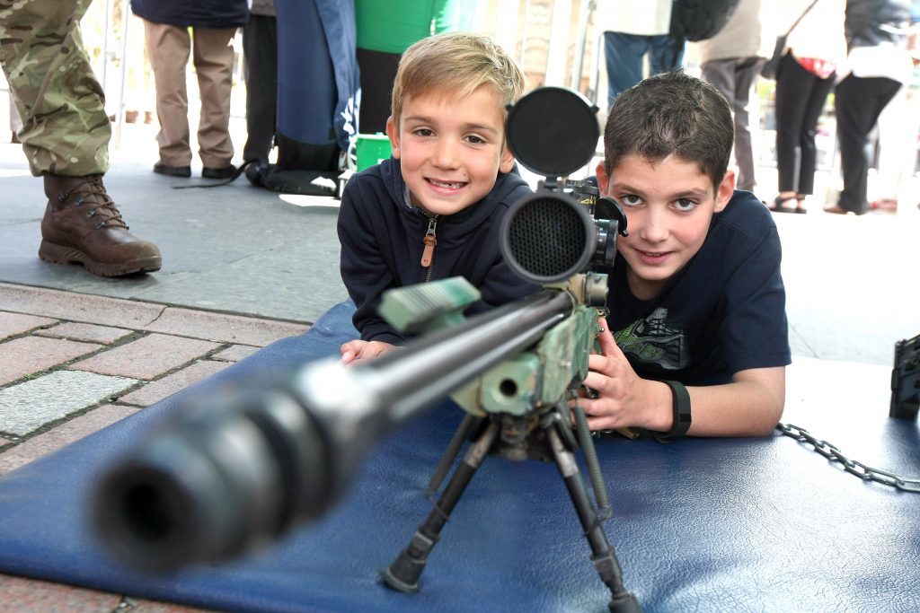 Max and Lewis Raeside with a Royal Marines rifle.