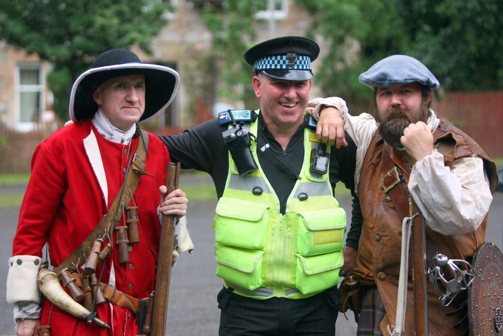 A Perth and Kinross Council traffic warden posing with troops.