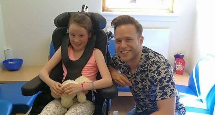 Olly posing with Emma during his surprise visit.