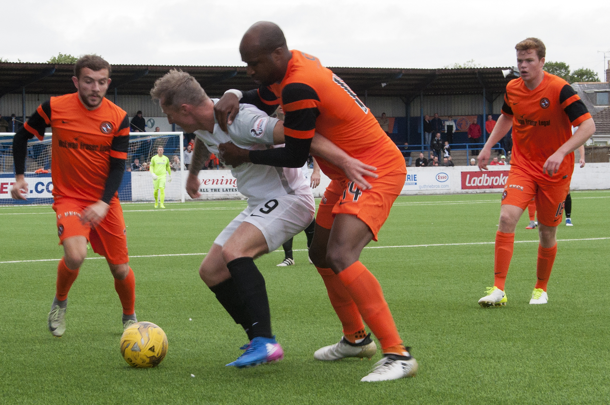 United defender William Edjenguele sticks tight to Gary Fraser as Paul McMullan and Scott Allardice close in.