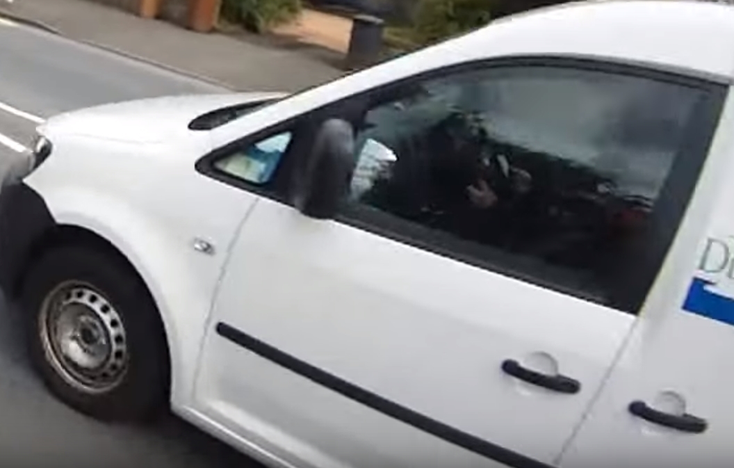 The driver is seen with a phone in his hand while heading along the Arbroath Road.