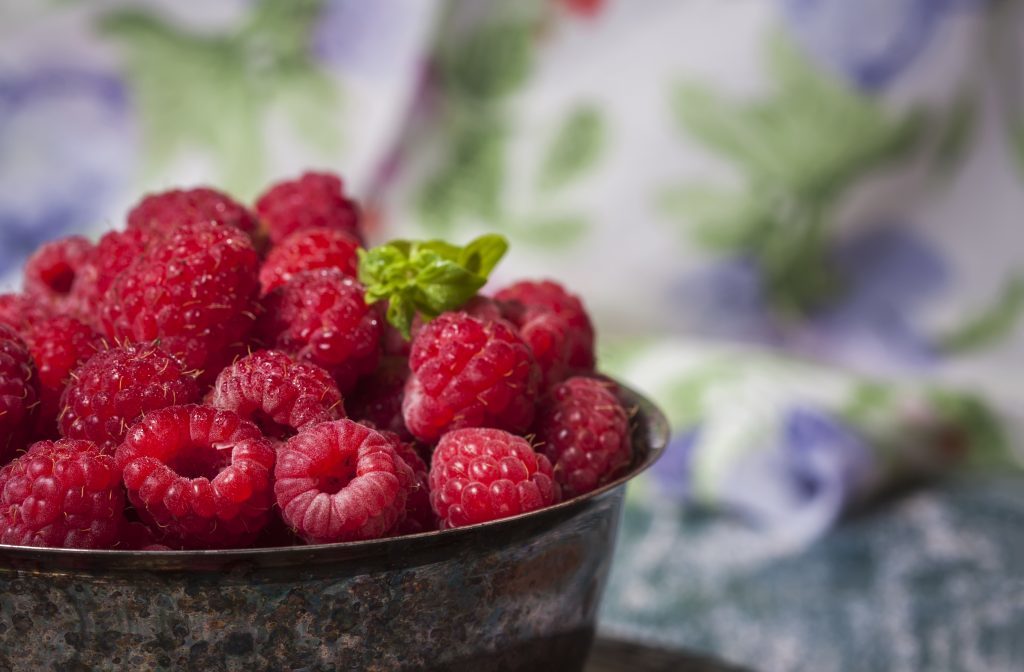 Fresh raspberries in vintage basket, vitamins, healthy food, ve