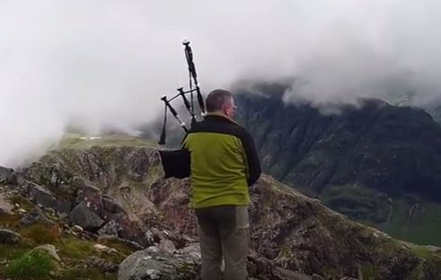 A lone piper plays on  Buachaille Etive Mòr. Credit: Bruce Melrose on Youtube.