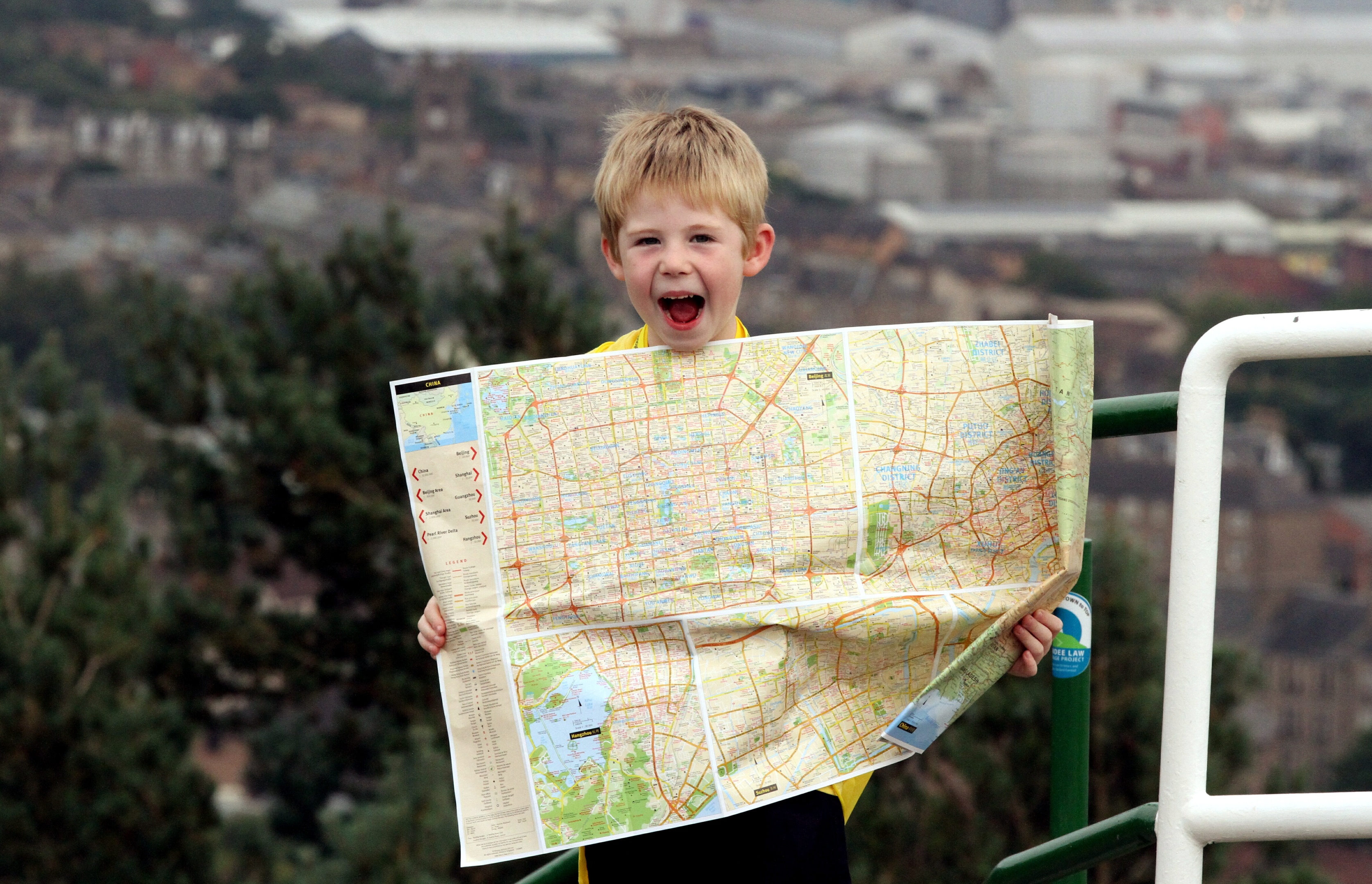 Shay McCormack on top of the Law with his backpack and his map of China, ready to start his walk.