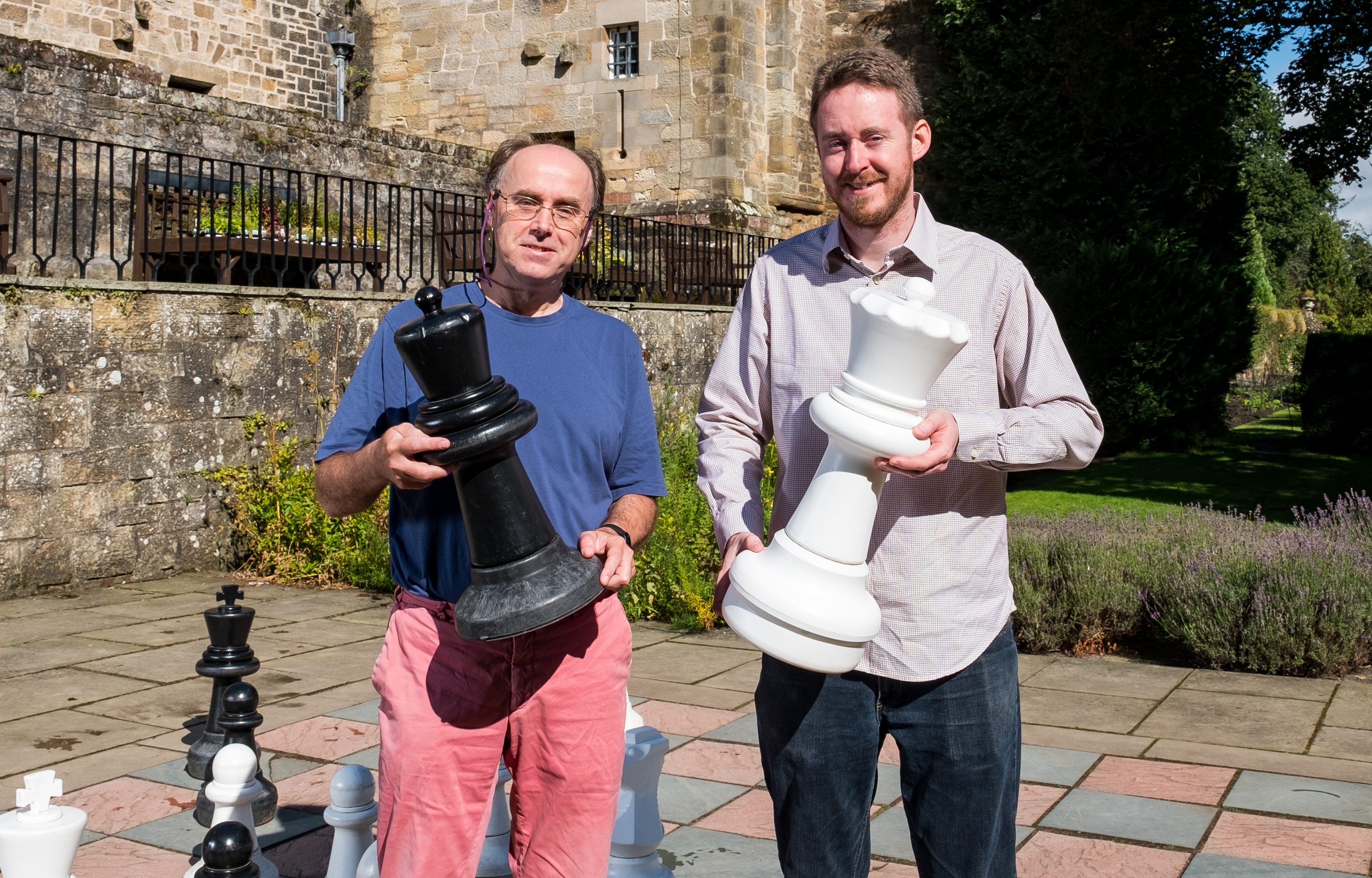 Professor Ian Gent and Dr Peter Nightingale attempt the puzzle with the giant chess set at Falkland Palace.