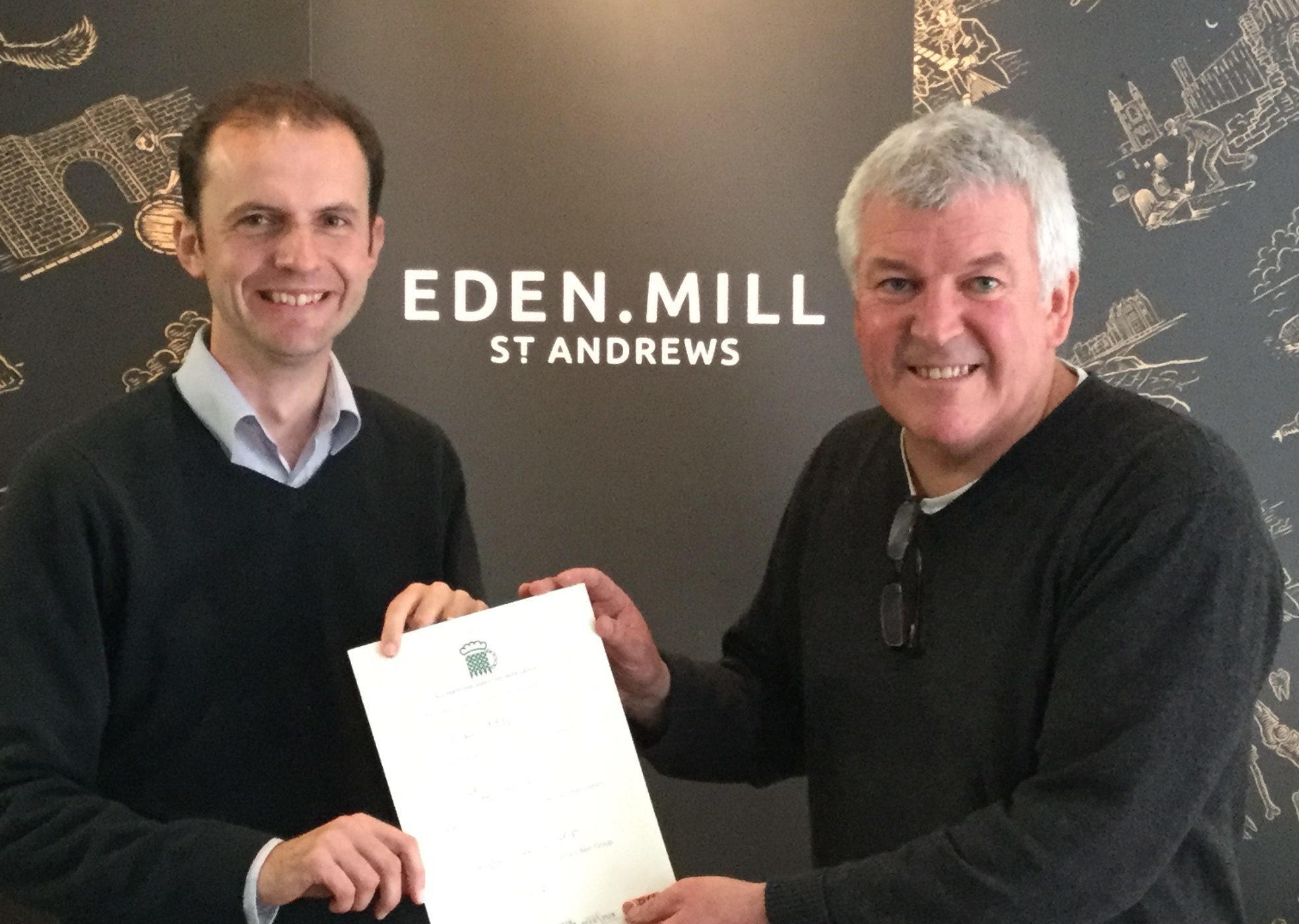 North East Fife MP Stephen Gethins presents a certificate to Eden Mill founder Paul Miller