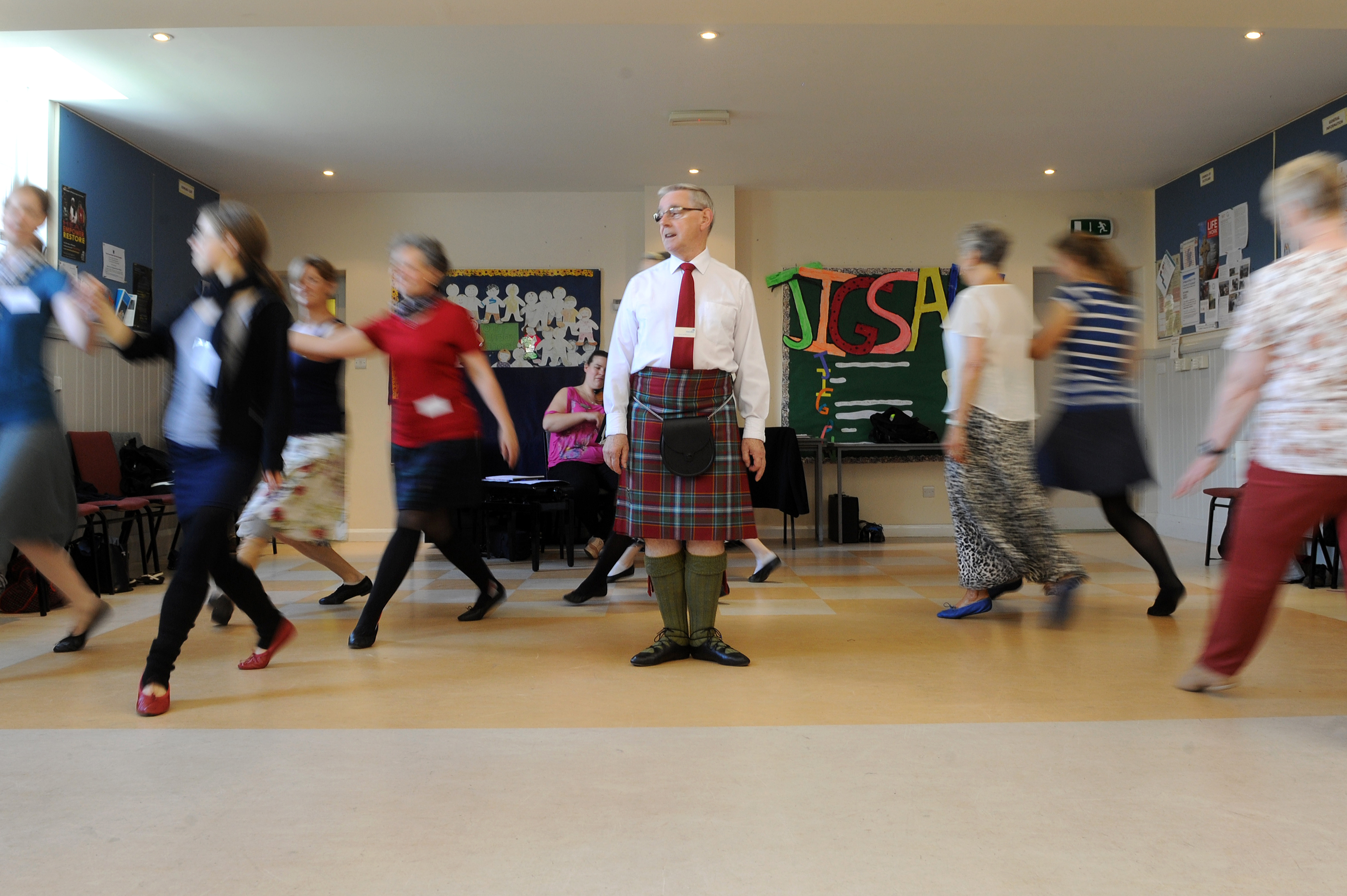 s; John Wilkinson instructing a dance class with violinist, Shona MacFadyen,