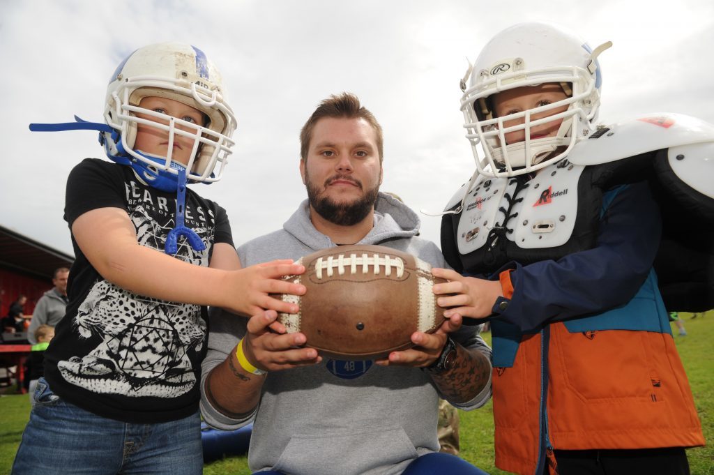 Trying out American Football on Beacon Green were l to r - Brogan Taylor (7), Conar Taylor (Hurricanes team member) and Harry McMaster (5), Arbroath.