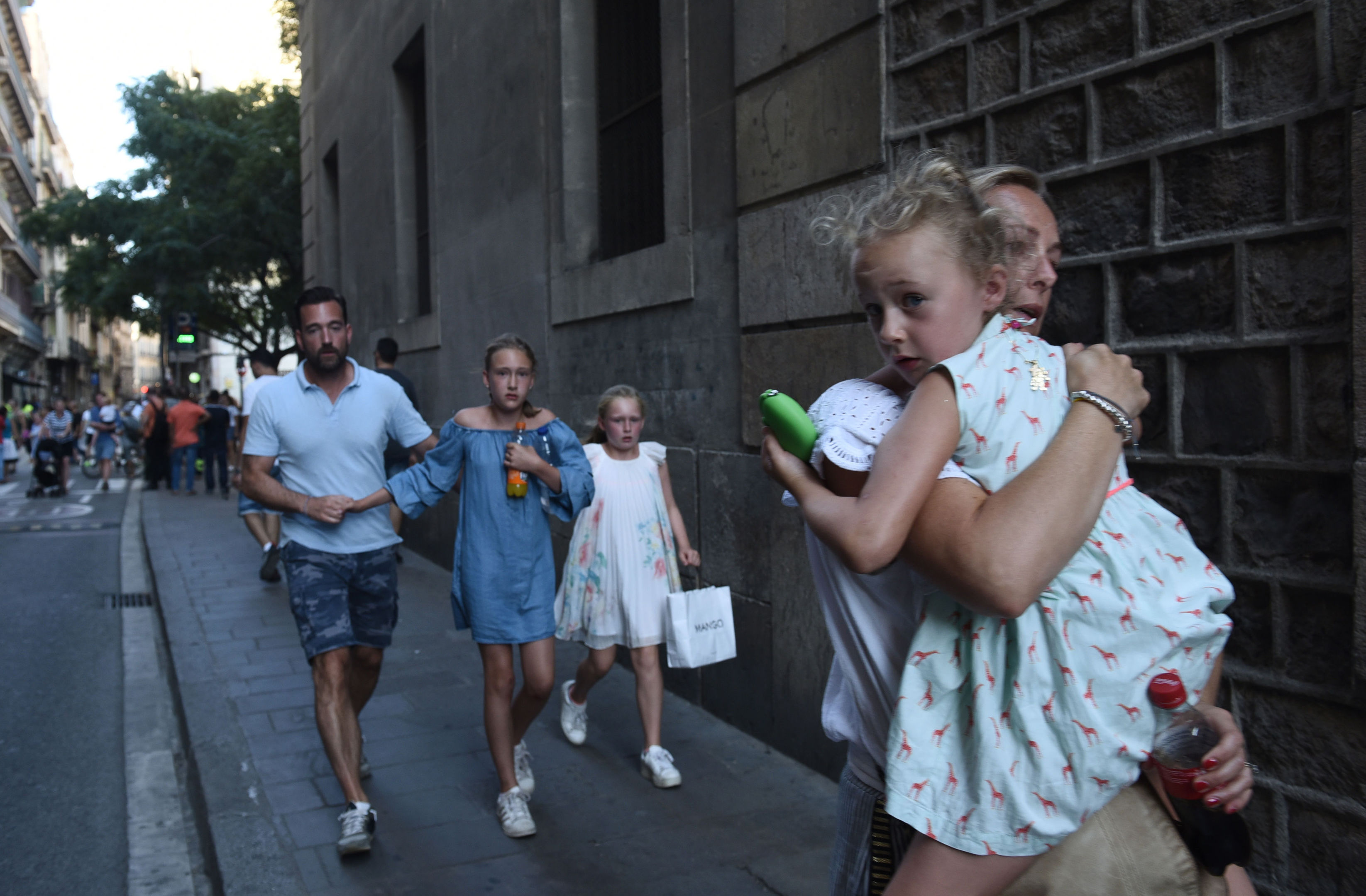 People flee the scene in Barcelona, Spain.