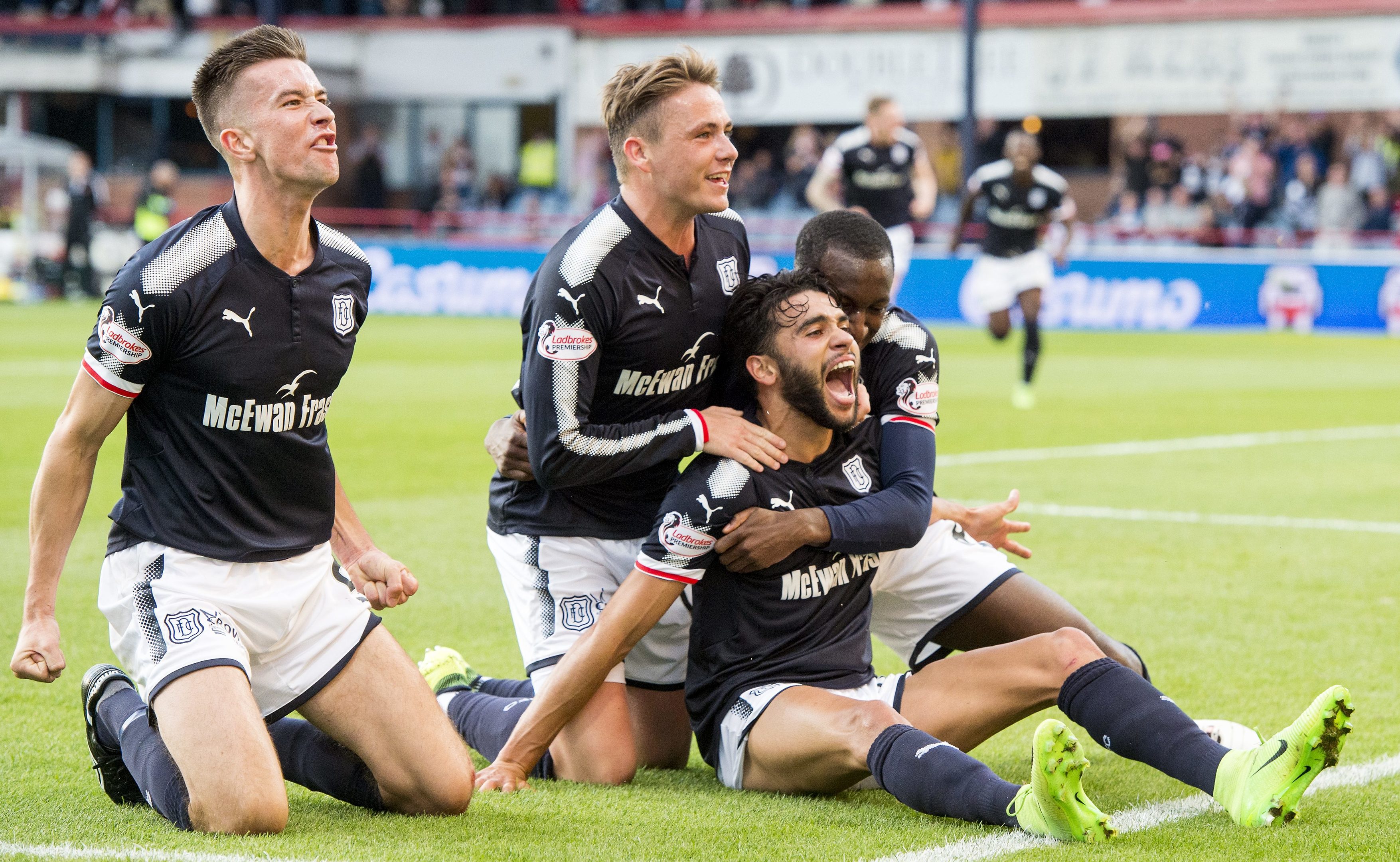 The Dundee players celebrate the opening goal.