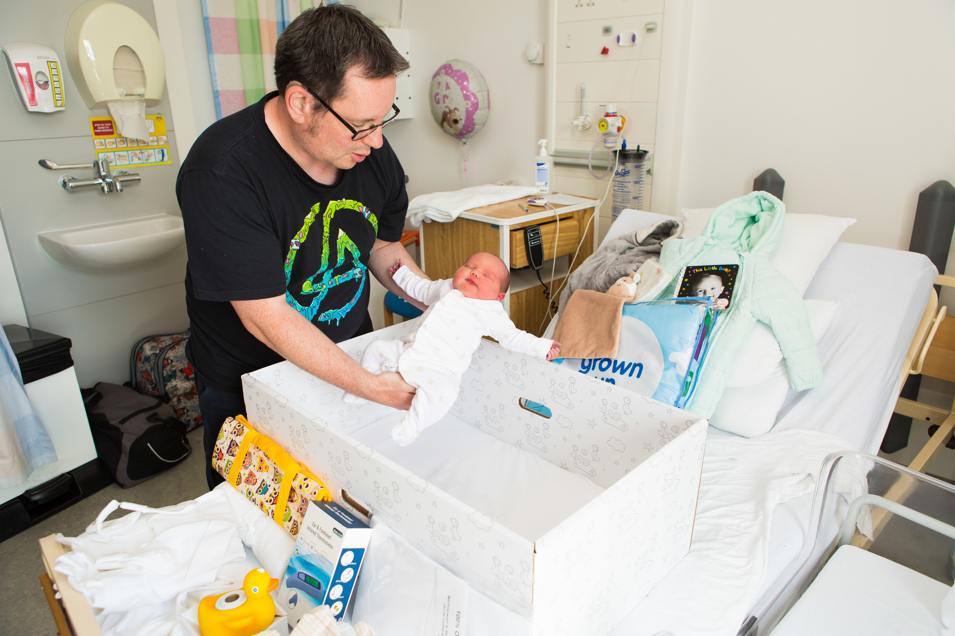 Baby Emma-Lily and her father Lee Hughes (40) try out the first baby box to be delivered to Fife.