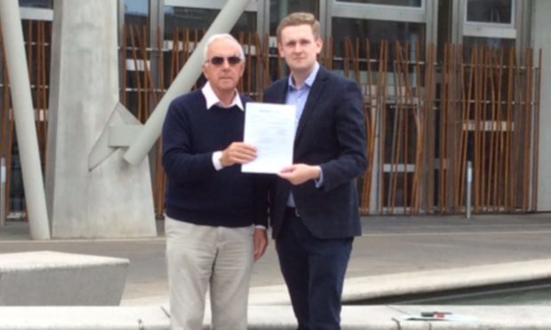 John Anderson (left) and Perth and Kinross Councillor Callum Purves with the petition calling on the Scottish Government to protect Blairingone from development.