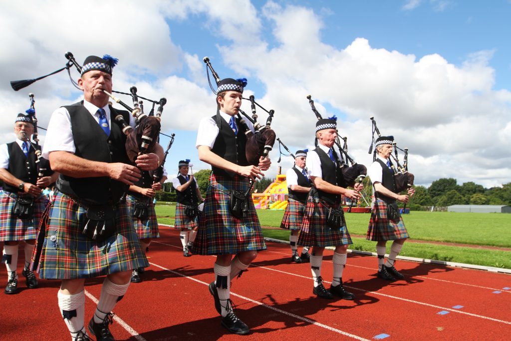 Pipers marching round the first lap.