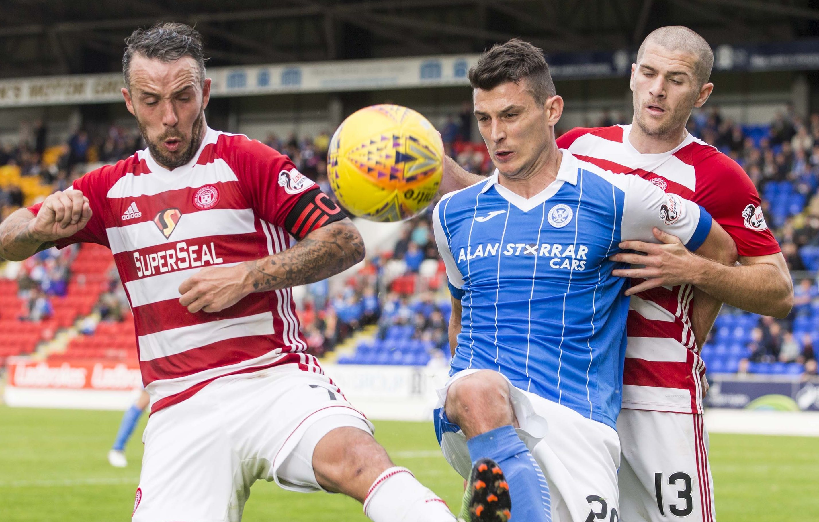 Hamilton's Dougie Imrie and Alex Gogic challenge St Johnstone's Graham Cummins.