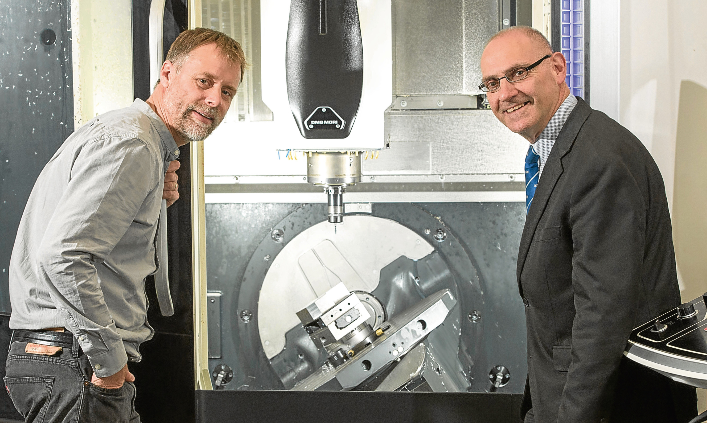 John Mitchell, managing director at Sterling Precision Engineering Services and Charles Davidson from Bank of Scotland with the new milling machine