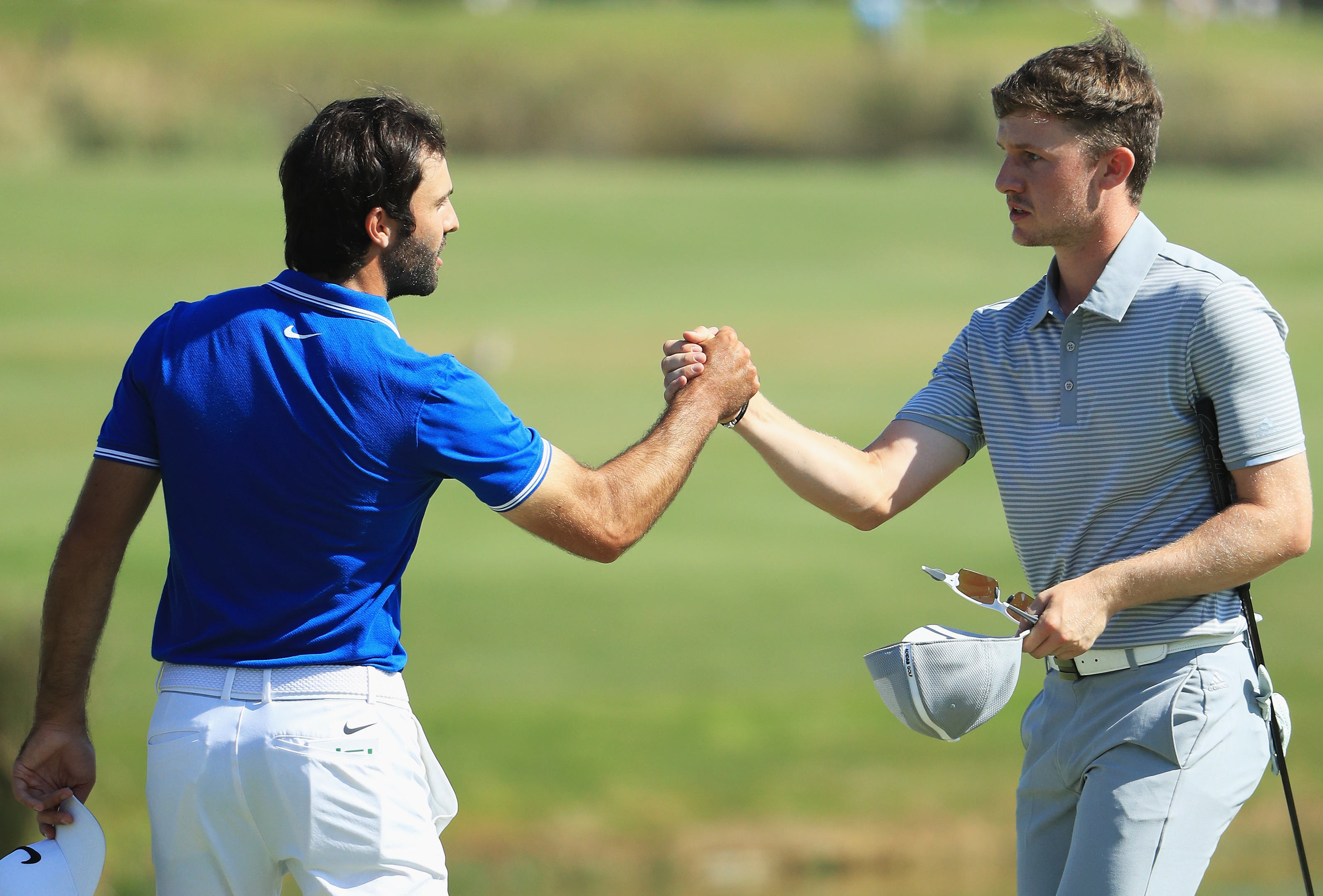 Connor Syme (R) of Scotland shakes hands with playing partner Joel Stalter at the end of yesterday's final round in Portugal.