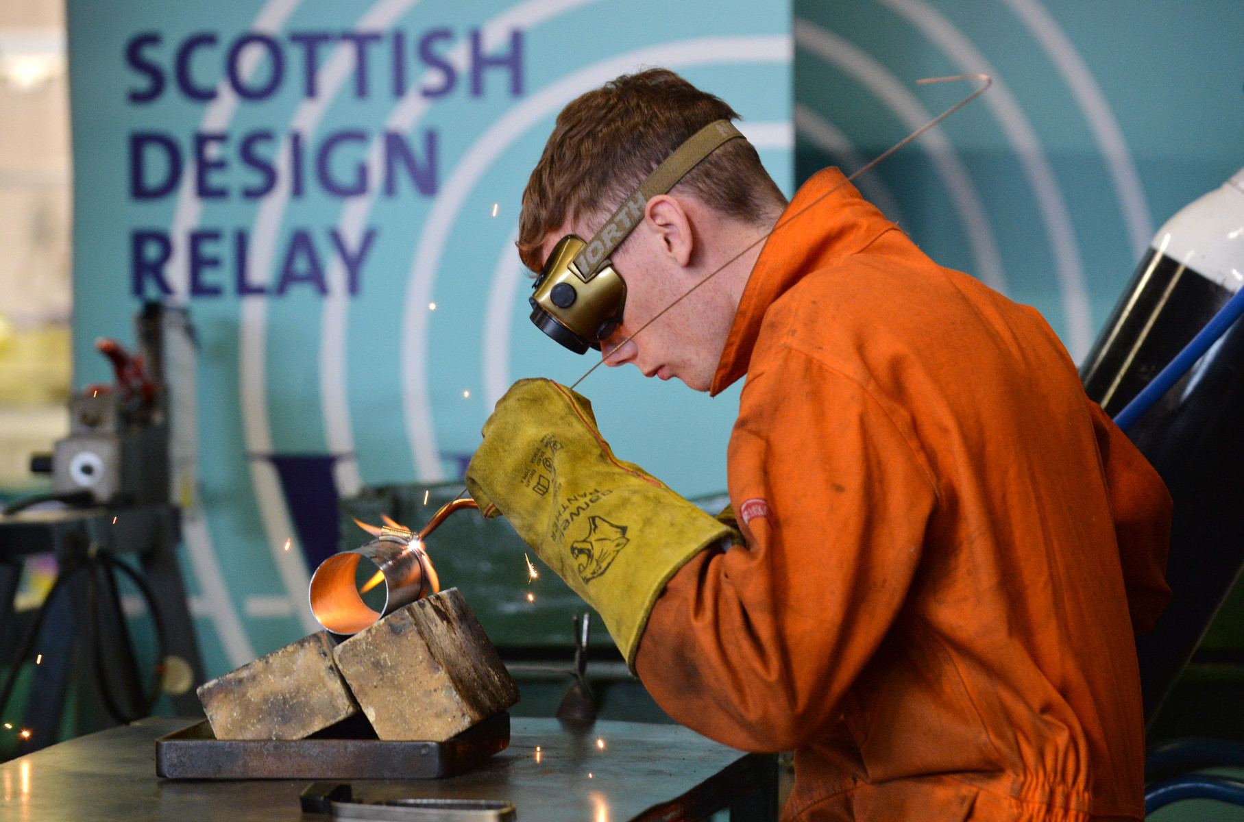 Michelin apprentice engineer Glenn Wheelans welds a piece of rolled metal plate to form part of the outer casing of the final prototype.
Photo by Julie Howden