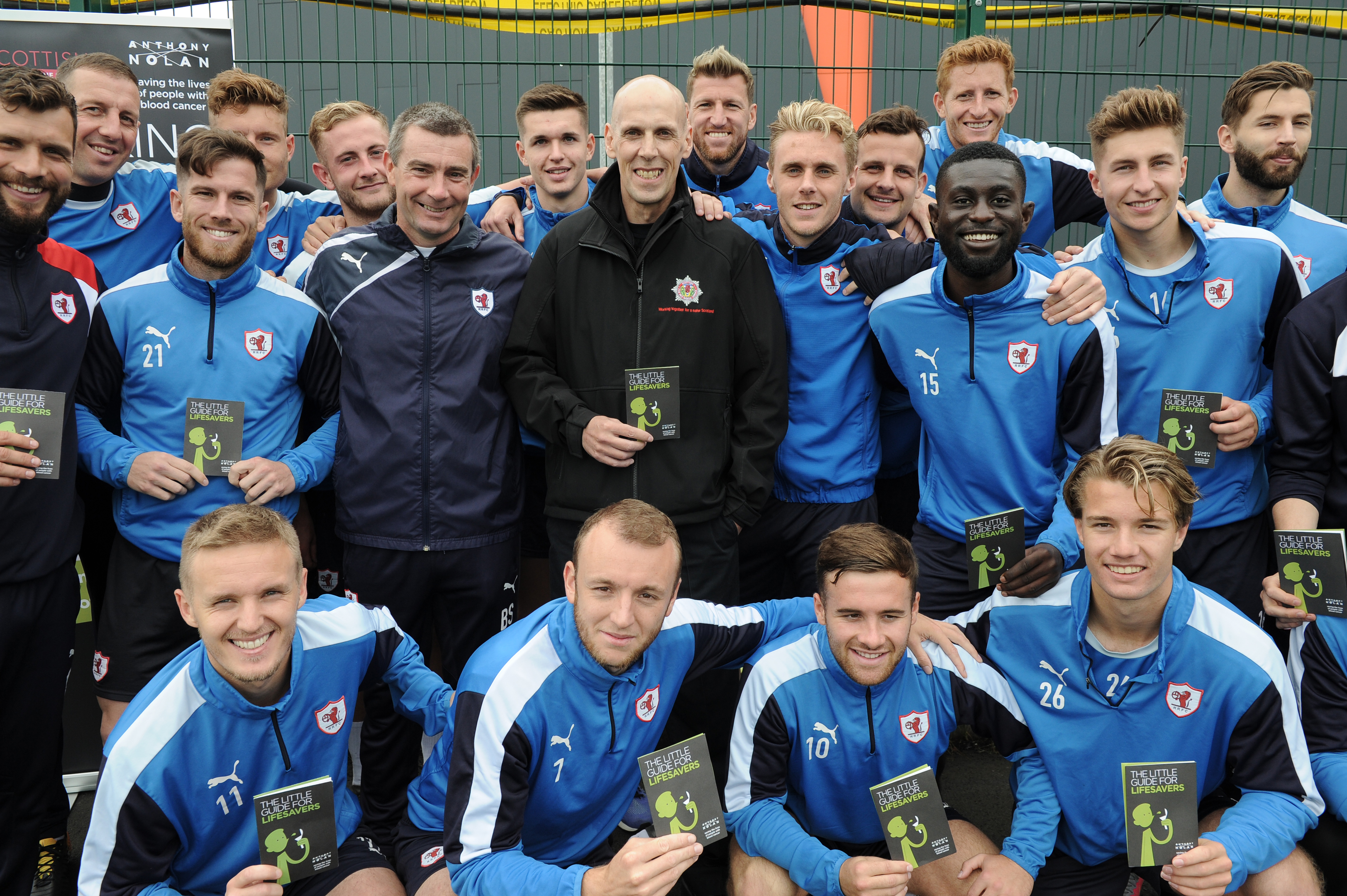 Firefighter Gary Dall (centre) with Raith Rovers players earlier this month.