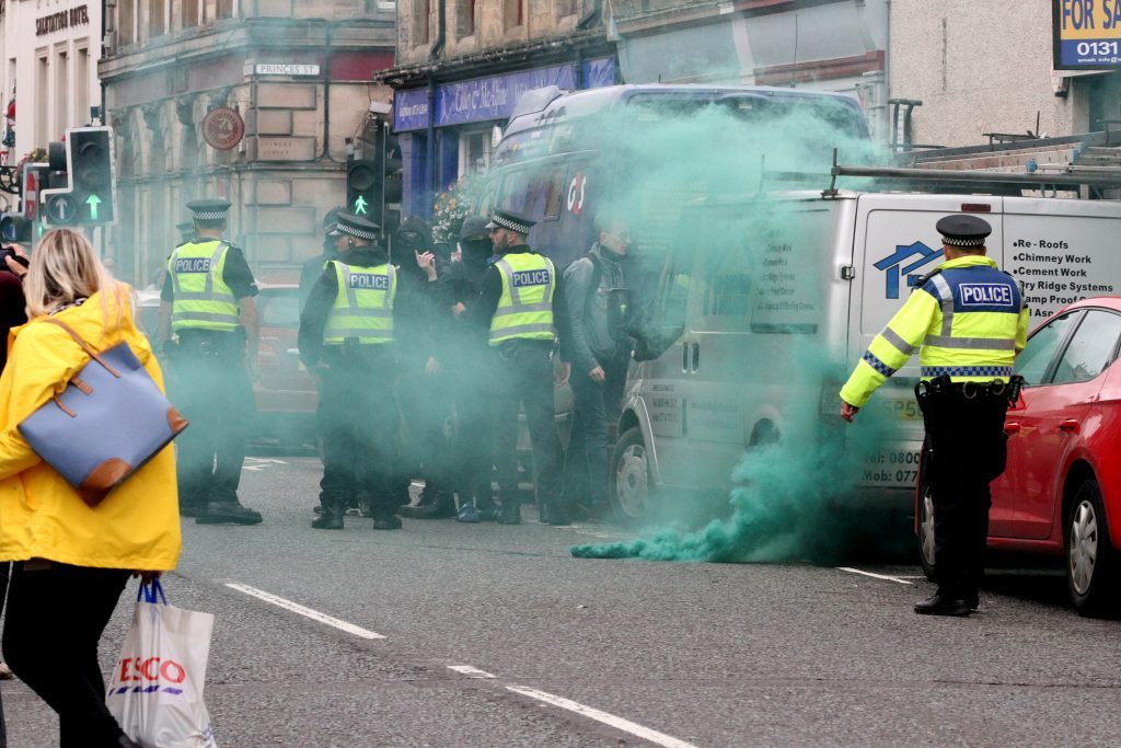 A gas canister is let off by a group protesting against the SDL