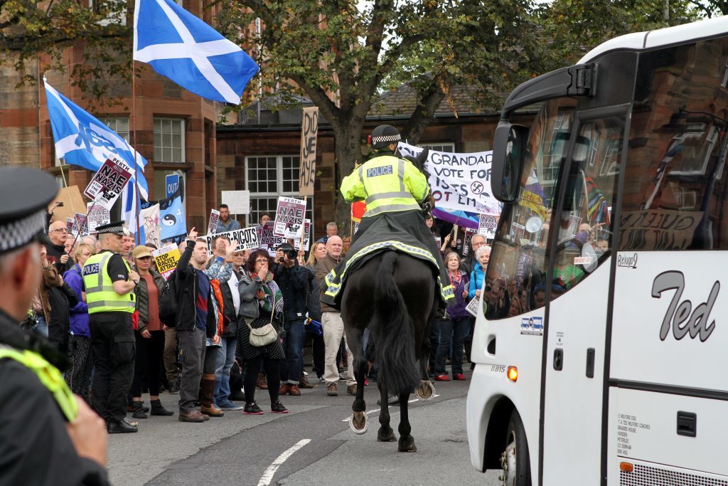 Mounted police on the scene as a bus full of SDL supporters arrives in Perth.