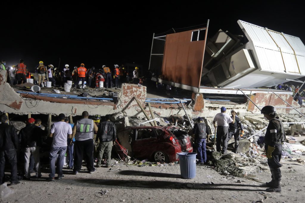 Rescue personnel work on a four storey building that collapsed after an earthquake, in the Colonia Obrera neighborhood of Mexico City
