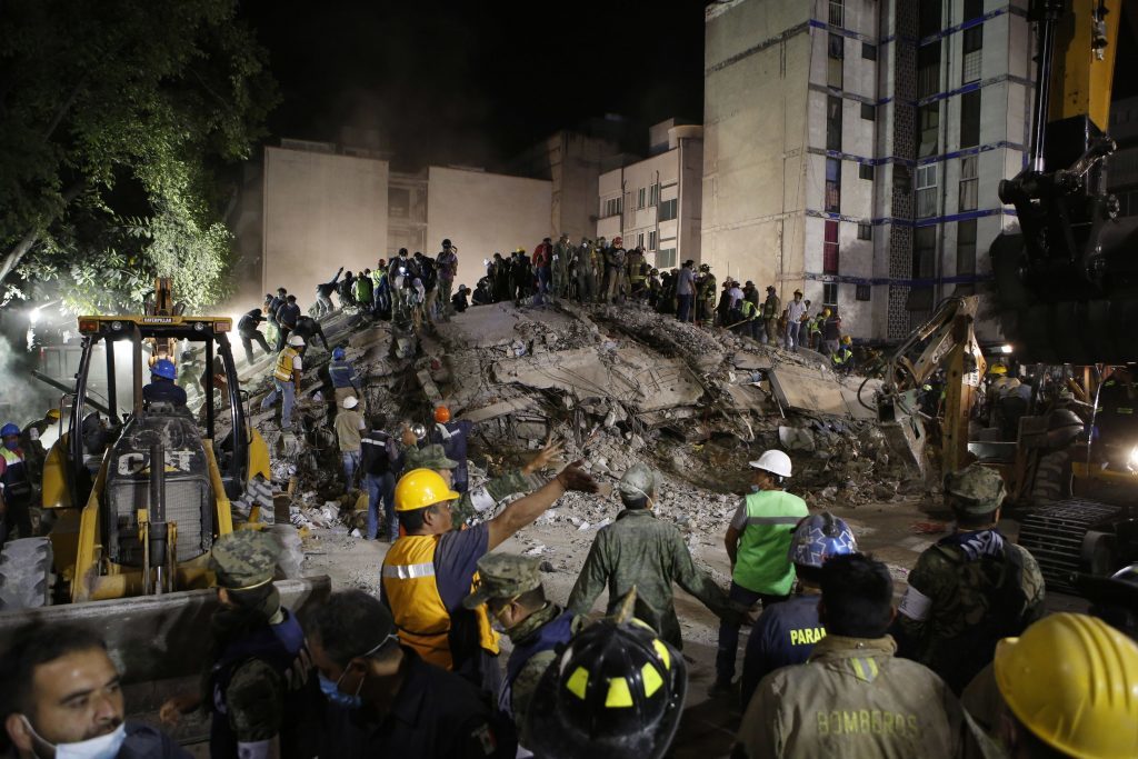 Rescue workers search for people trapped in a collapsed building in the Piedad Narvarte neighborhood of Mexico City
