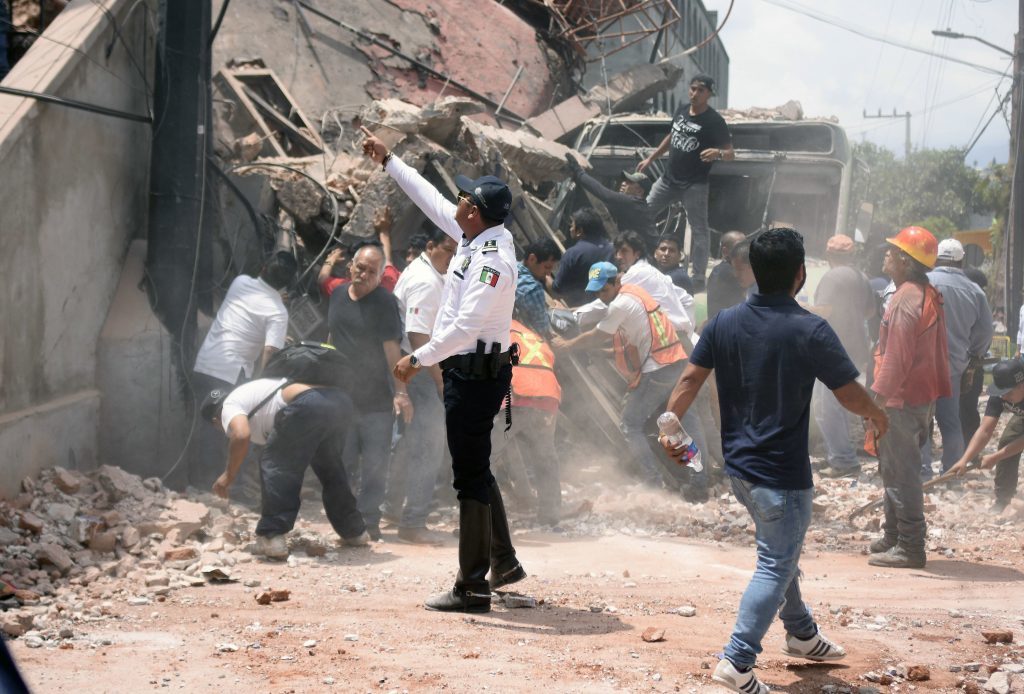 Rescue personnel work on a building that collapsed after an earthquake in Cuernavaca, Morelos state