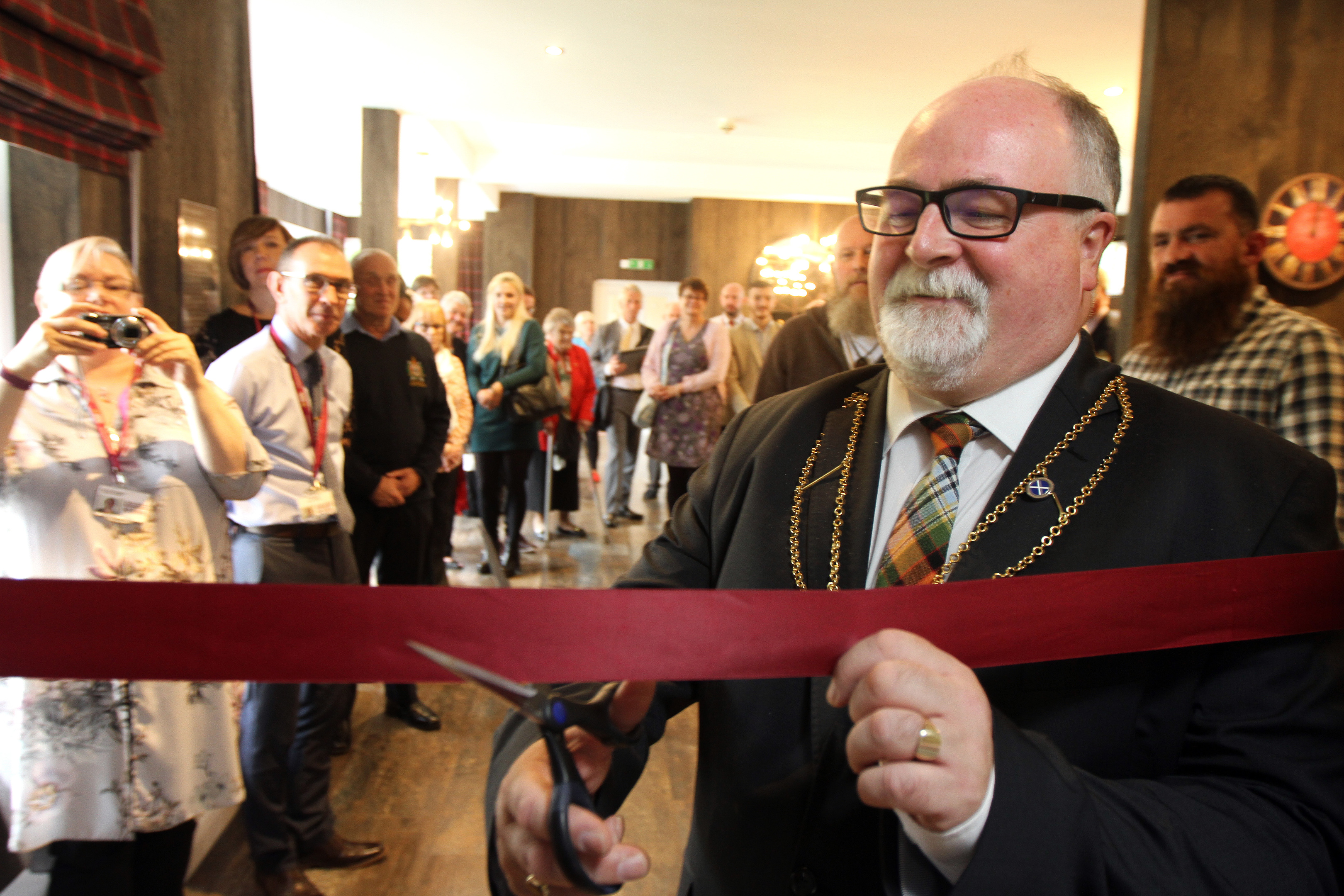 Bill Campbell cutting the ribbon at Rosendael House.