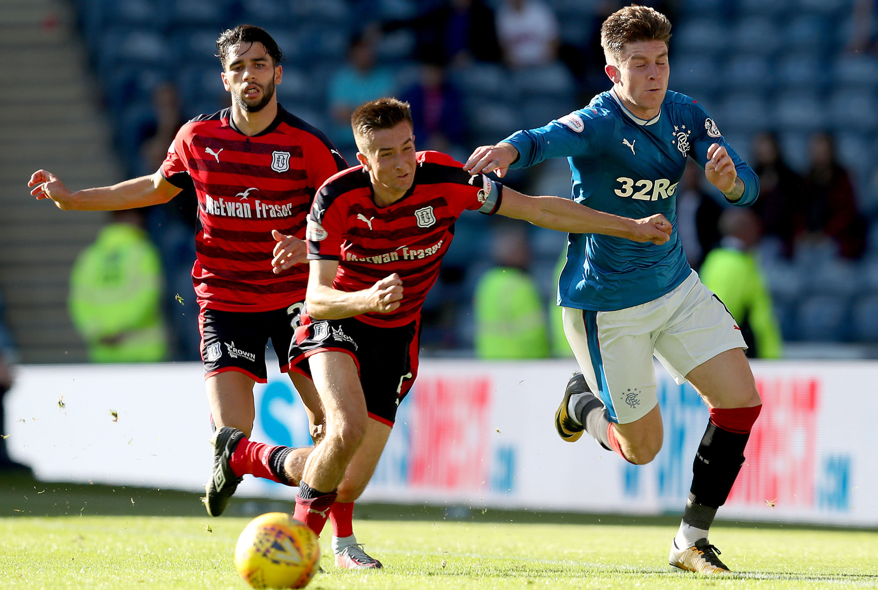 Rangers' Josh Windass and Dundee's Cammy Kerr battle for the ball during the Ladbrokes Scottish Premiership match at Ibrox