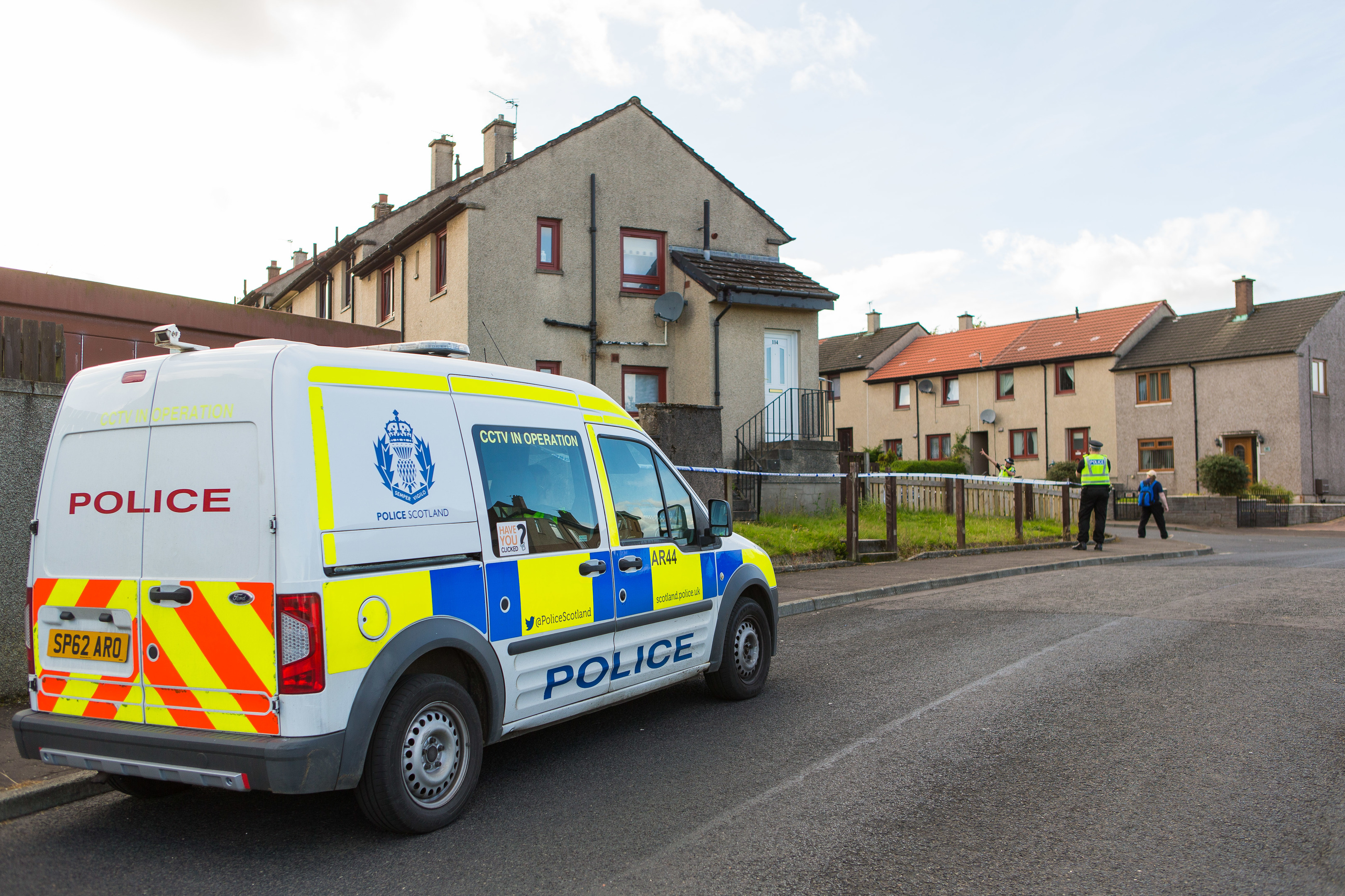 Police outside a house in Kelty where the body was found