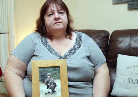 Yvonne Heath with a photograph of James Collinson.