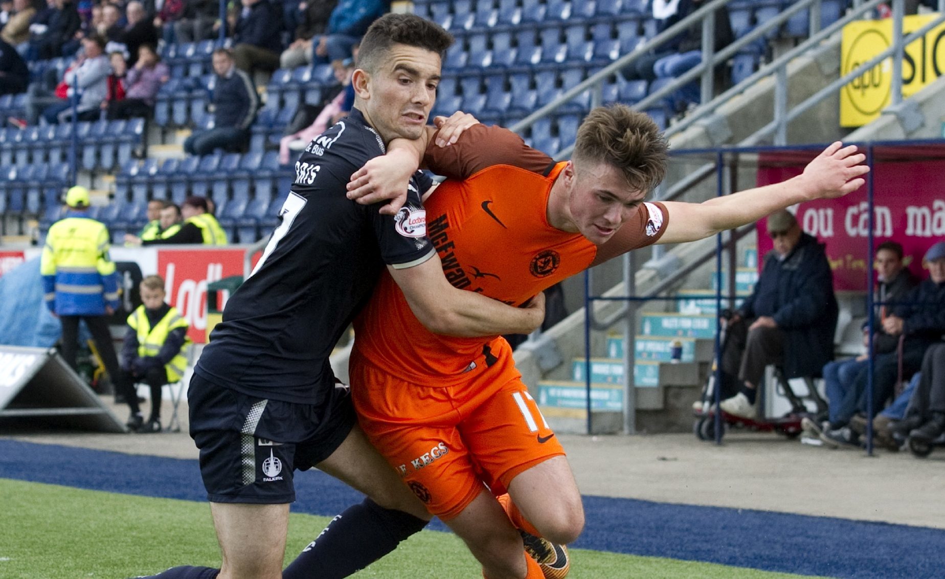 Jamie Robson of United battles with Falkirk's Alex Harris.