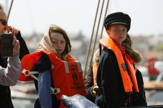 Fisher lad and lass Adam Lockhart and Molly Scott on board The Reaper during last year's festival.