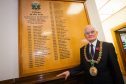 Lord Provost Ian Borthwick beside the board commemorating past winners.