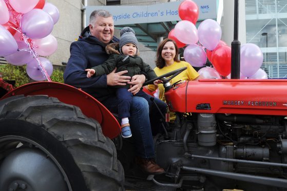 Mike Robertson Aiden's grandfather and chair of the Angus and Kincardine Ferguson Tractor Group, Aiden Johnston (1) and Emma White (ARCHIE Tayside fundraising nanager