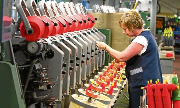 A technician oversees the yarn spinning process at Todd & Duncans Lochleven Mills at Kinross.