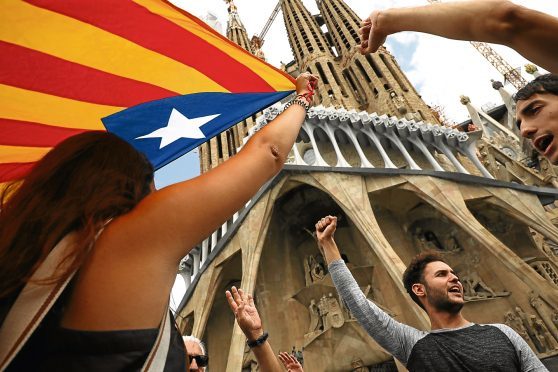 Citizens march with a Catalan flag in Barcelona.