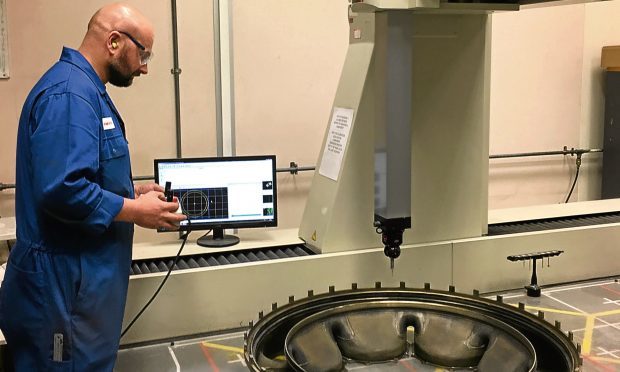 A Rolls-Royce industrial Olympus turbine entry duct is inspected at ATL Turbine Services.