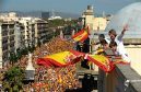 People wave Spanish flags in a protest in Barcelona against Catalan independence moves.