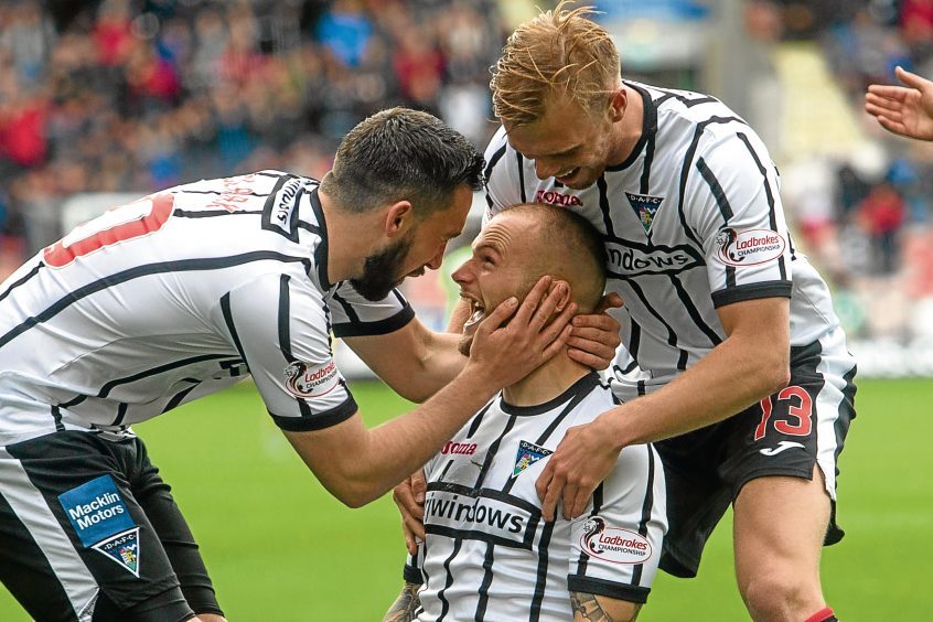 Kallum Higginbotham celebrates scoring for the Pars.