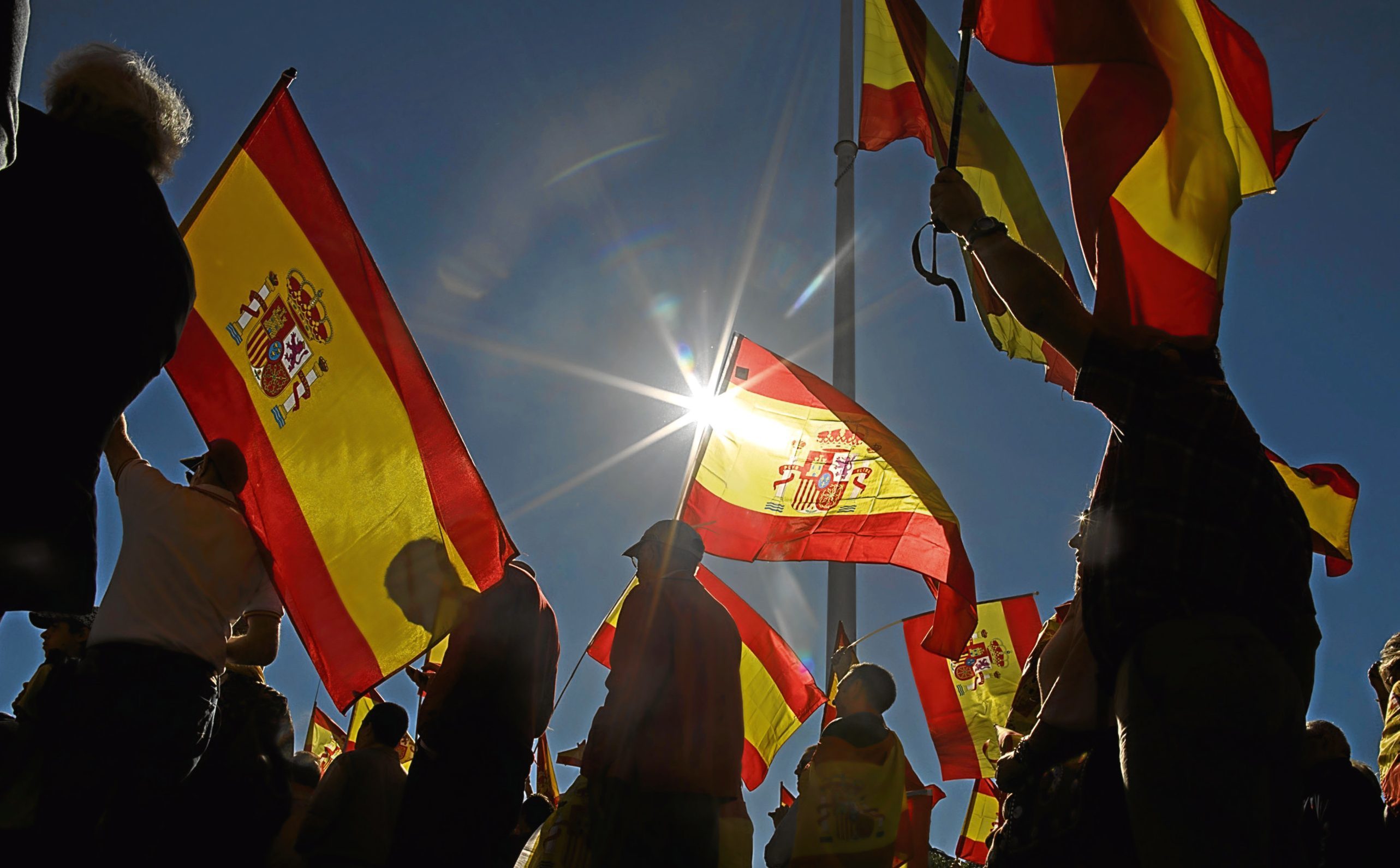 Demonstrators in Madrid hold Spanish flags as they protest in support of Article 155 and against the independence of Catalonia.