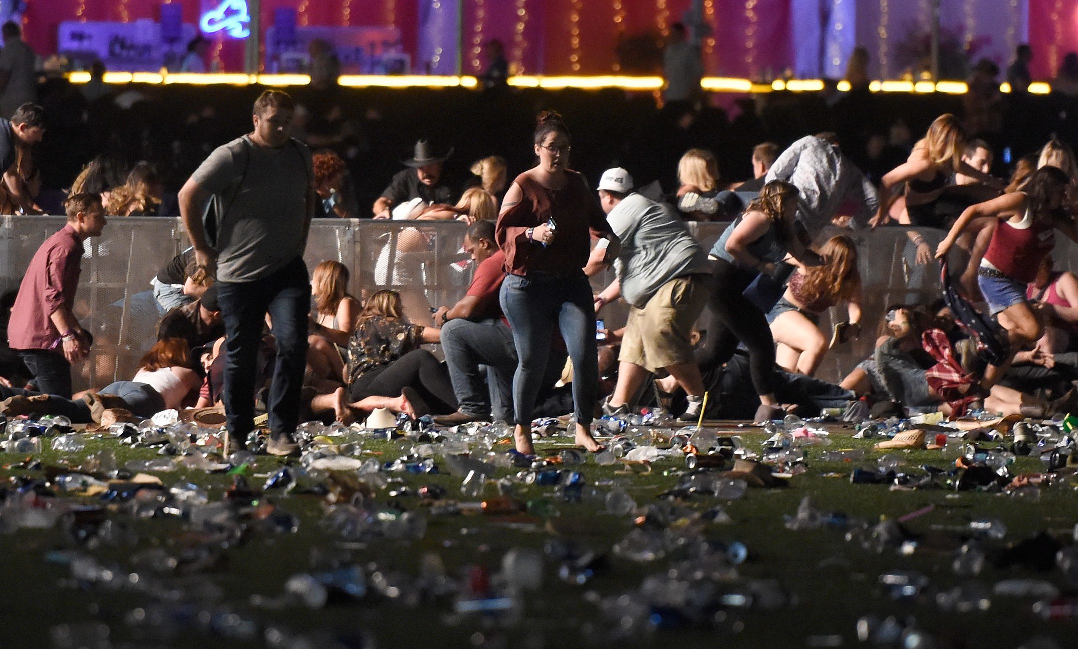 Young people run for safety as the shooting continues.