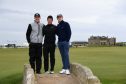 Connor Syme, Rory McIlroy and One Direction's Niall Horan pose for photos on the Swilcan Bridge yesterday.