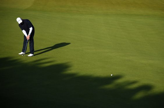 David Drysdale putts on the 12th green at Kingsbarns on his way to a 67.