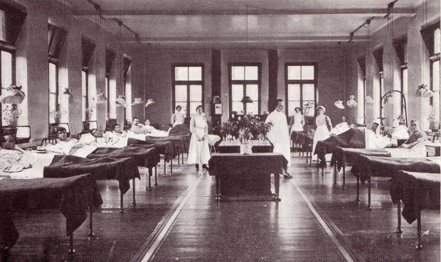 A nurses' station in between two rows of beds at a Dundee war hospital