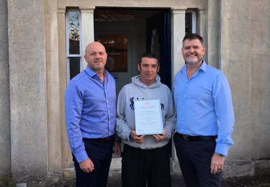 Neil Reilly receives the Royal Humane Society Resuscitation Certificate from Kilmac director Richard Kilcullen (left) and Athole McDonald.