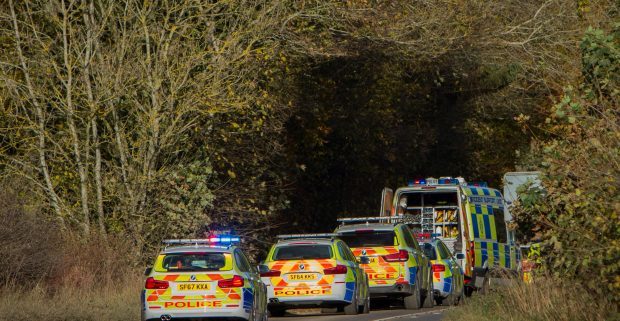 Police vehicles at the scene of the fatal accident.