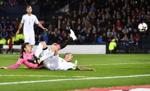 Chris Martin is beaten to the ball by Slovakian defender Martin Skrtel.